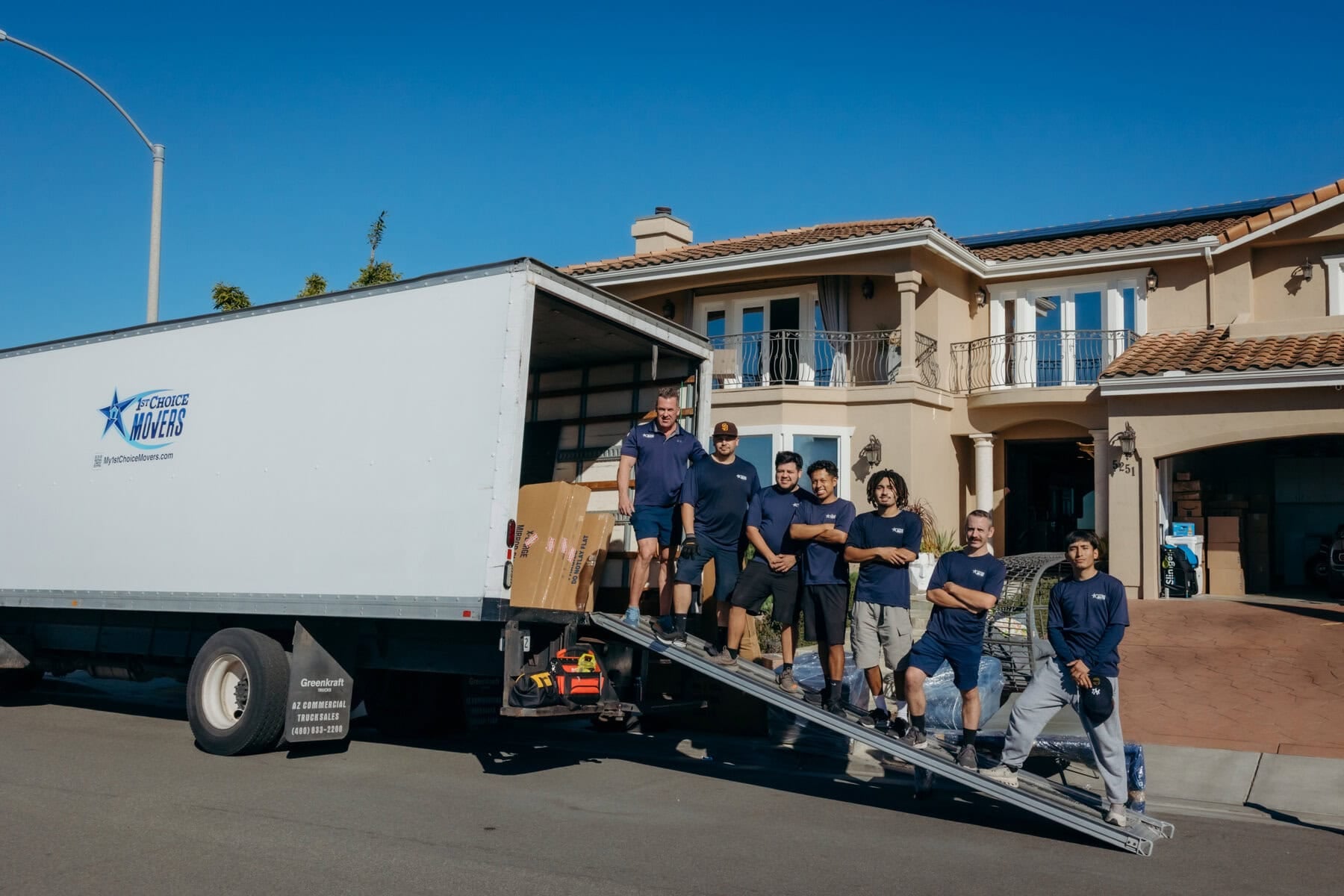 Movers loading a truck using a ramp at a luxury home in Clairemont, San Diego.