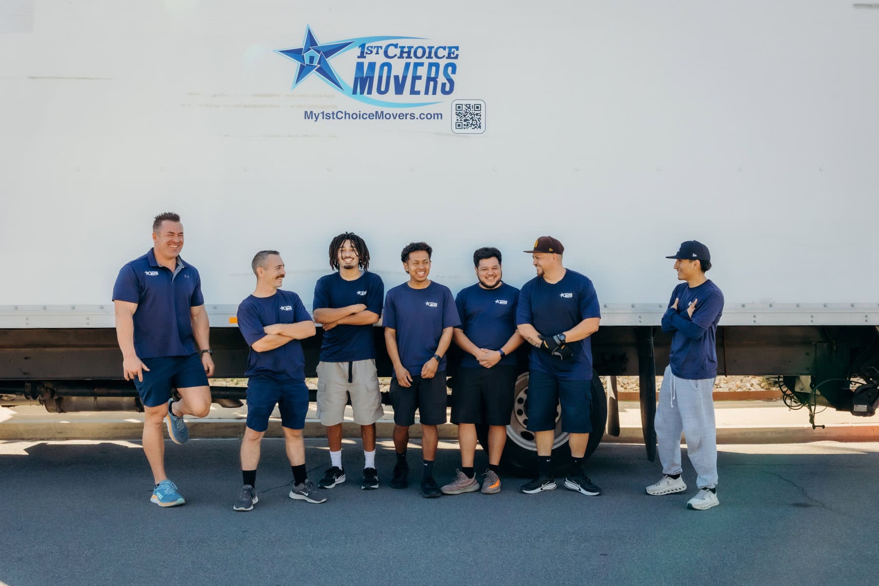 Reliable moving crew standing with a 1st Choice Movers truck for a residential move.