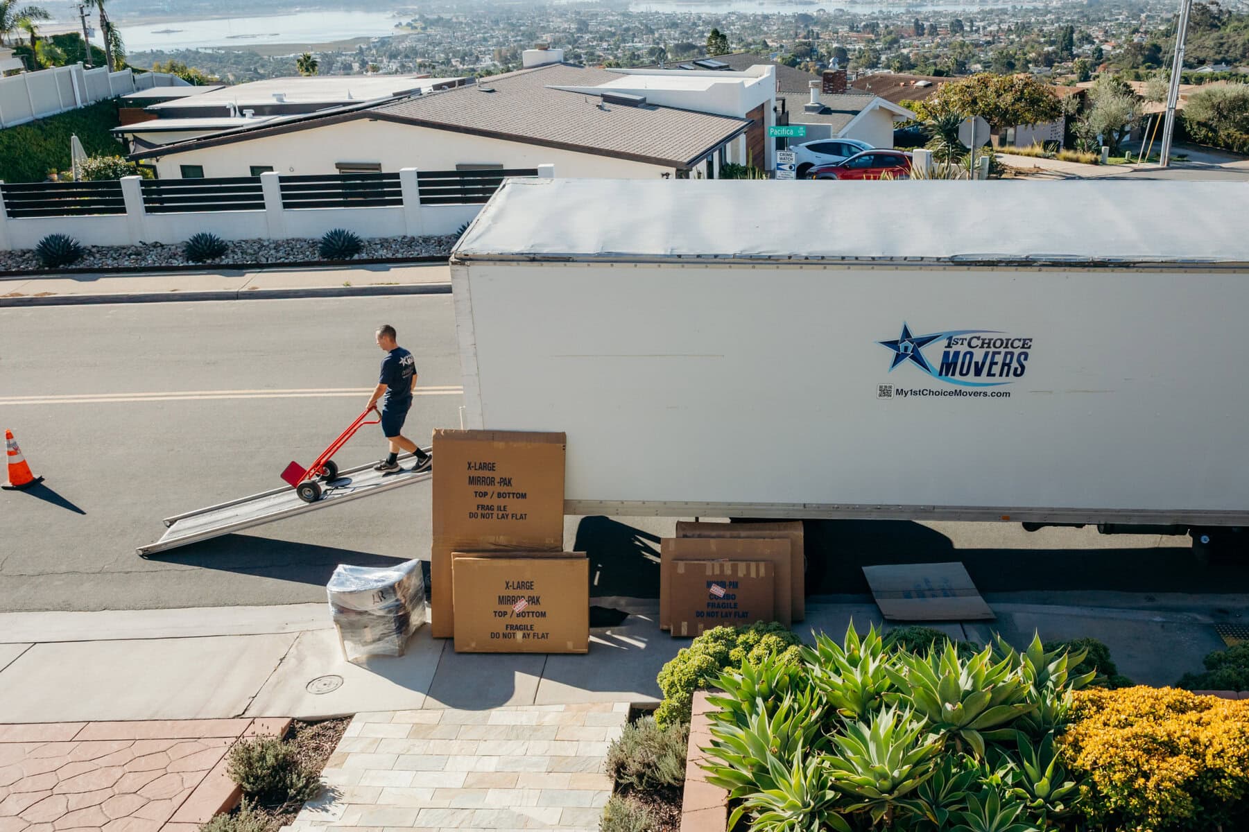 Moving professionals carefully loading heavy boxes into a truck for a local home move.